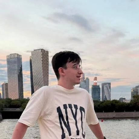 Daniel on the embankment, Moscow City towers behind
